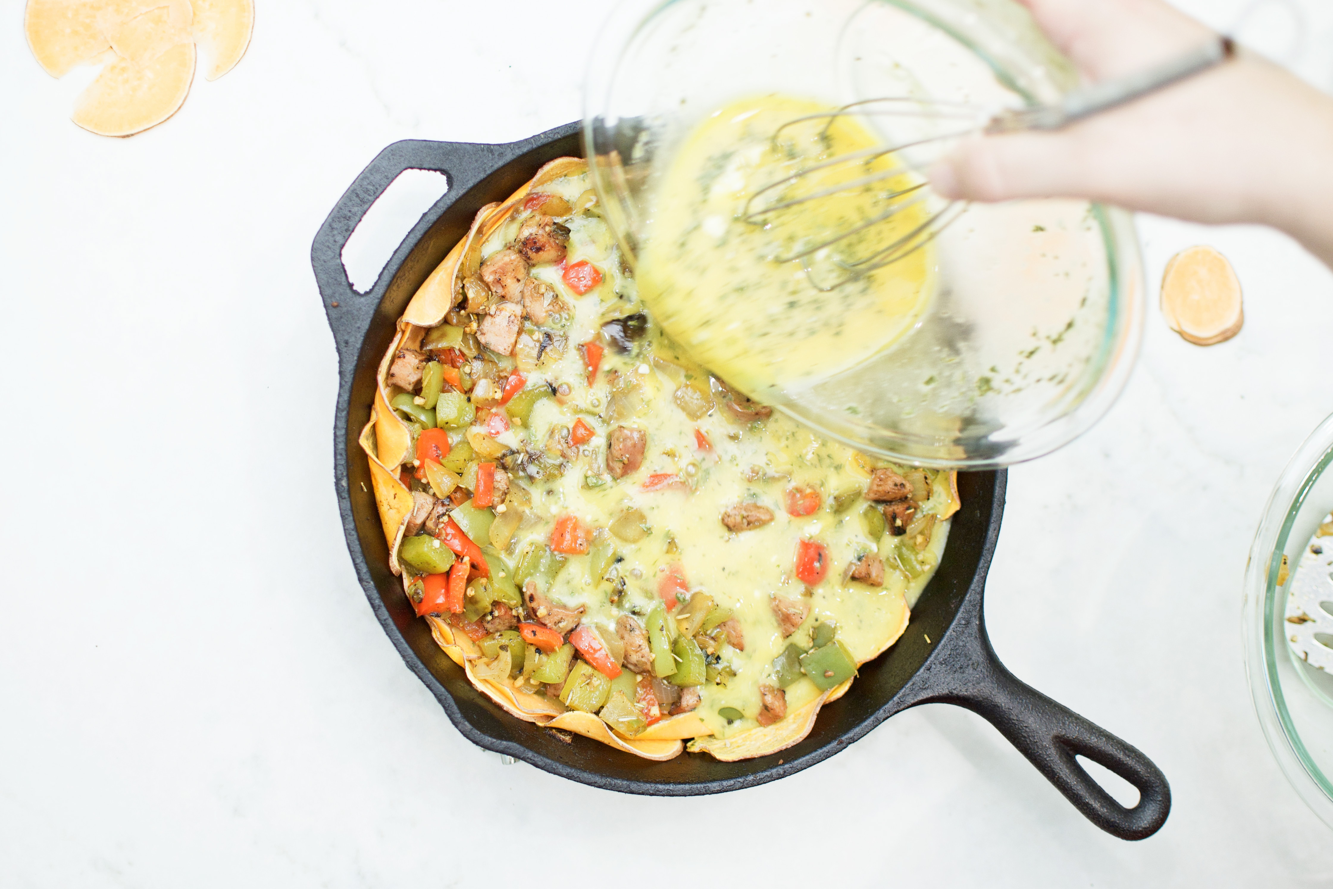 quiche, pouring eggs on meat veggies, skillet, top view