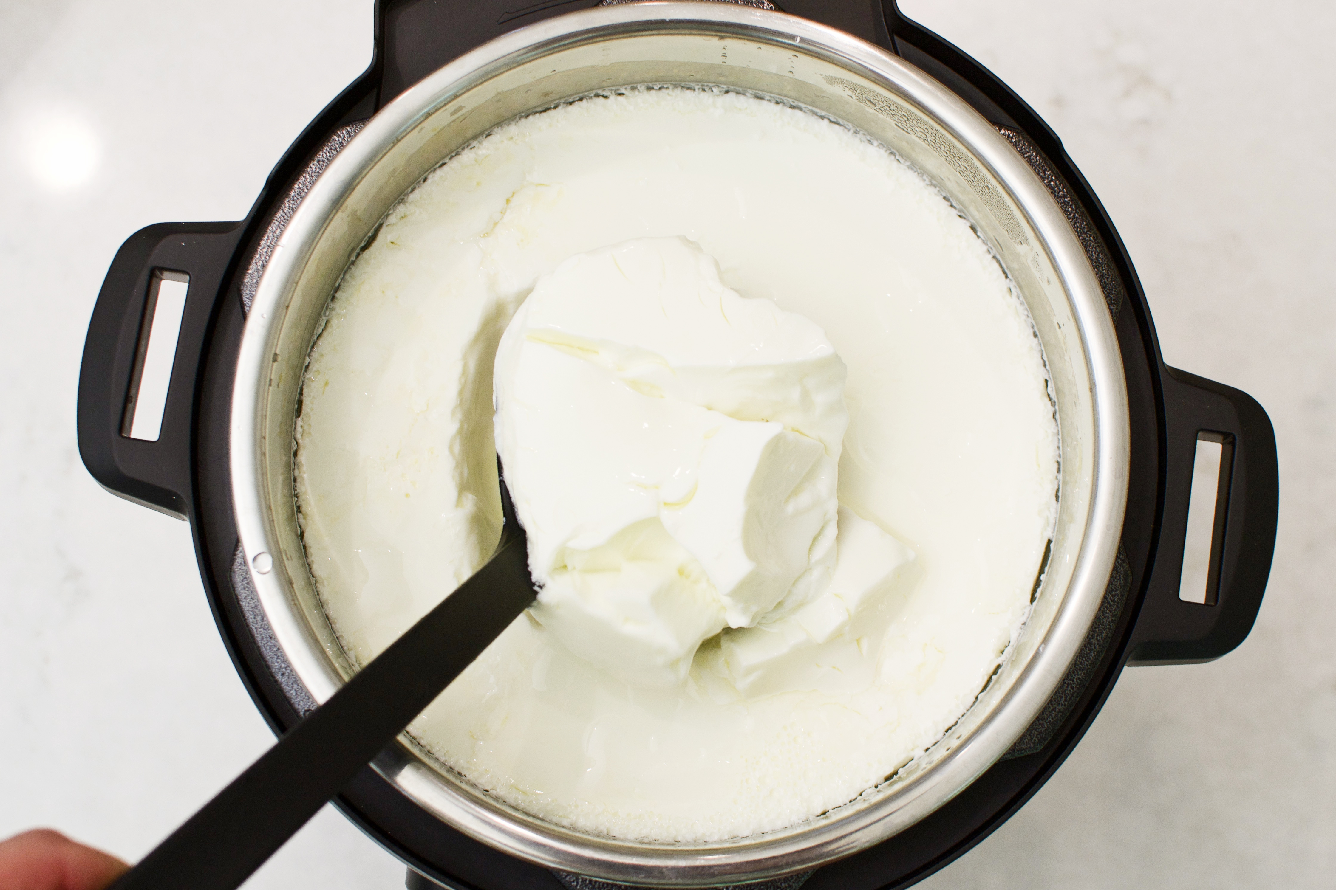 https://buildingourrez.com/wp-content/uploads/2018/07/instant-pot-yogurt-top-view-done-in-ladle.jpg