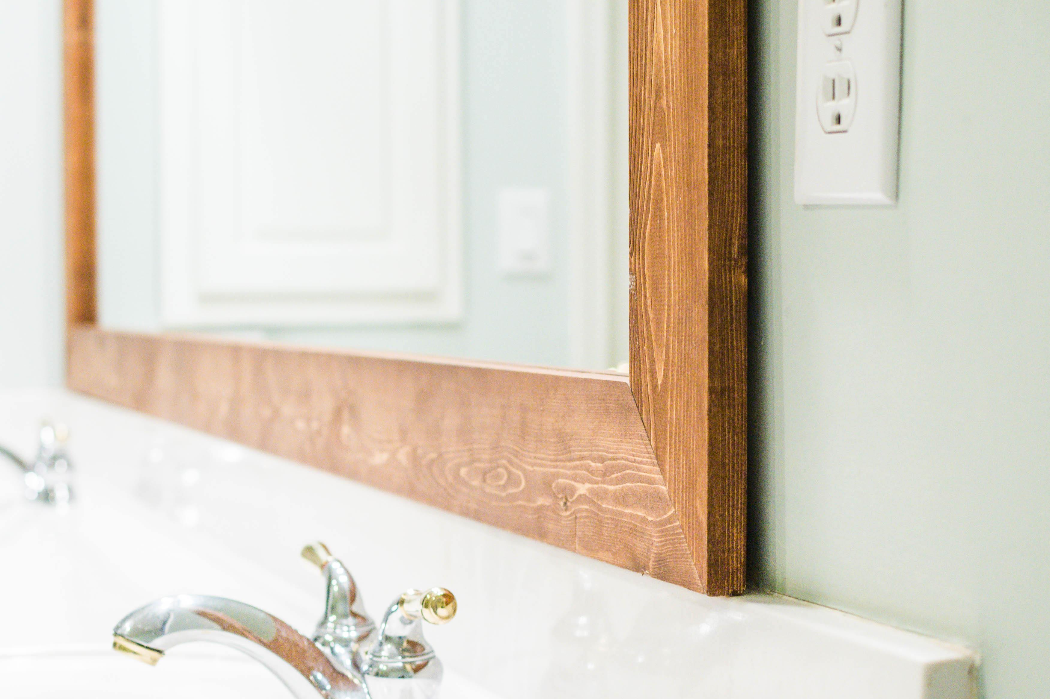 How to DIY Upgrade Your Bathroom Mirror With a Stained Wood Frame