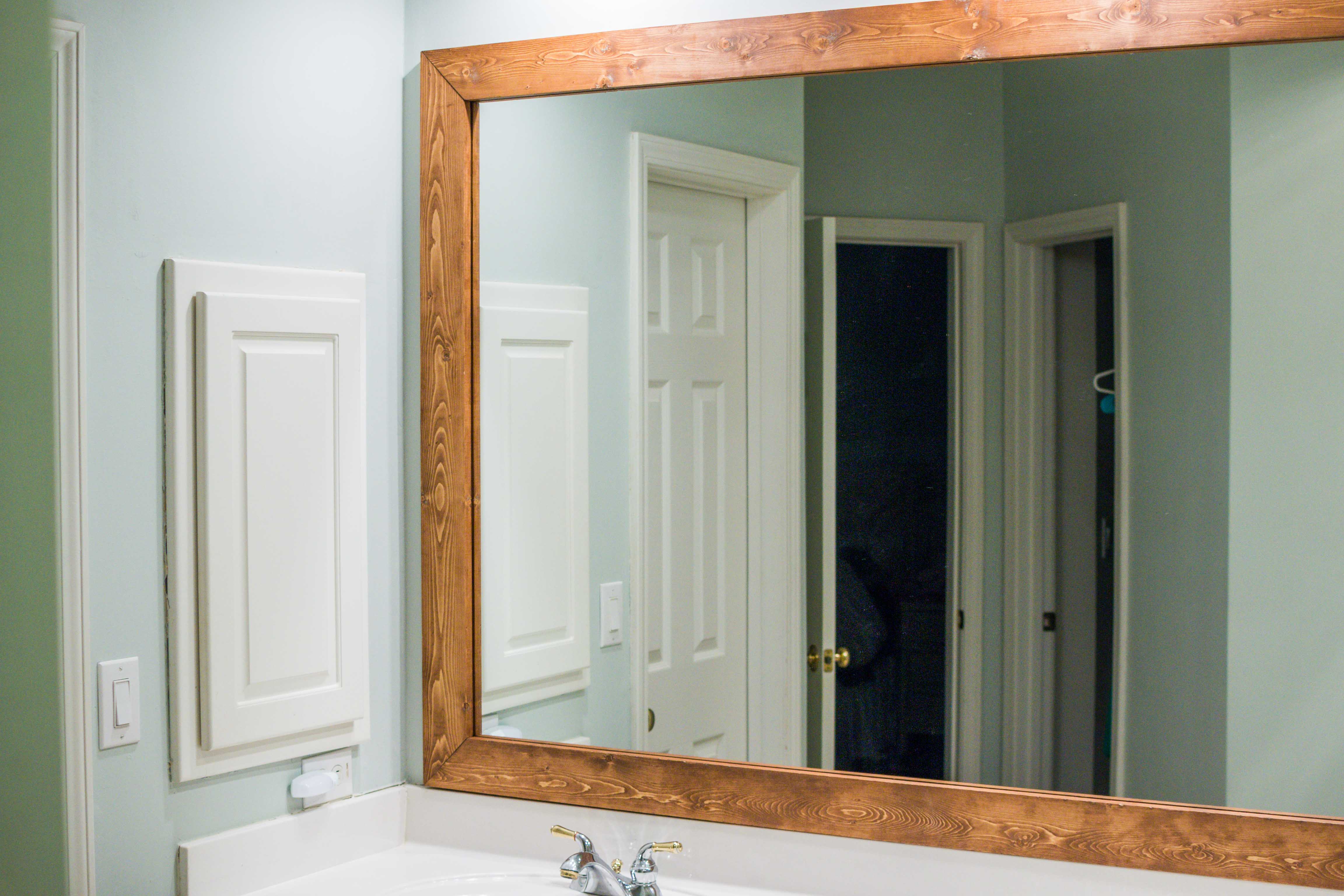 How to DIY Upgrade Your Bathroom Mirror With a Stained Wood Frame