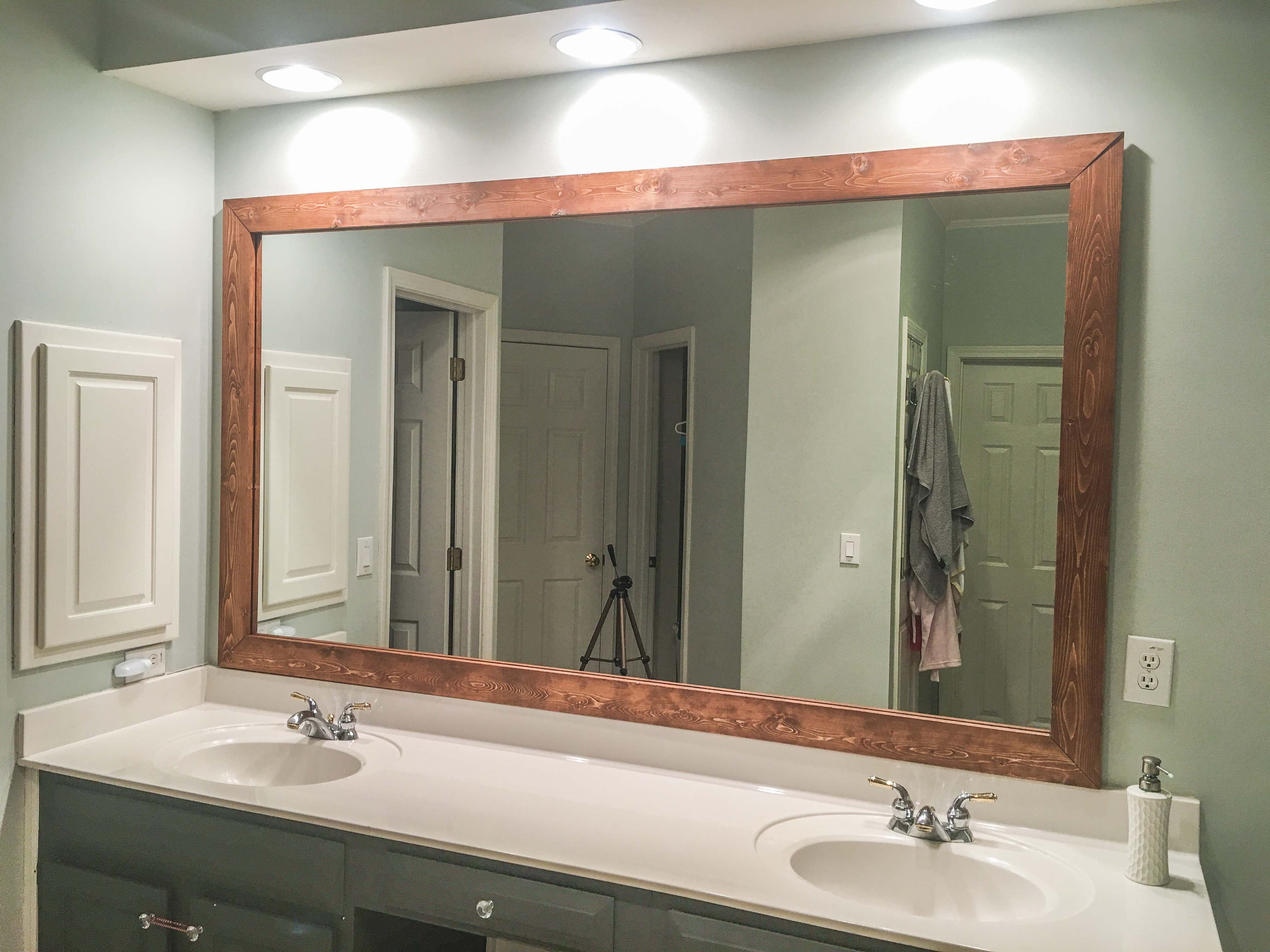 How to DIY Upgrade Your Bathroom Mirror With a Stained Wood Frame